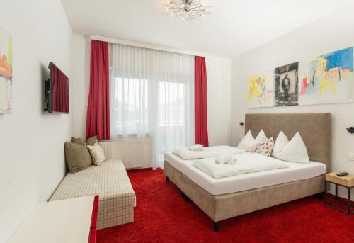 1 dormitorio con 1 cama grande y 1 sofá en Appartementhaus Modern Art by Schladming-Appartements, en Schladming