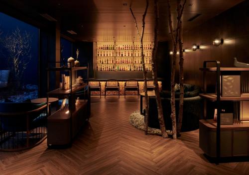 a room with a bar with a bunch of wine bottles at Fufu Kyu-Karuizawa Seiyou No Mori in Karuizawa