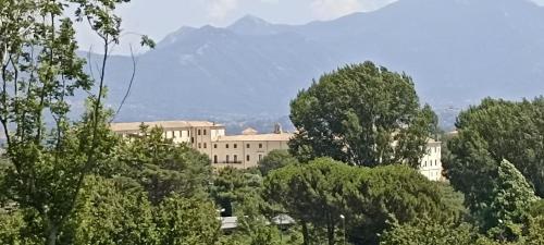 a large building with trees and mountains in the background at avellino camera centrale in Avellino