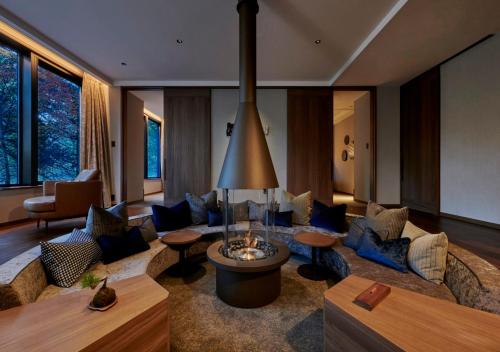 a living room with a large couch and chairs at Fufu Kyu-Karuizawa Seiyou No Mori in Karuizawa