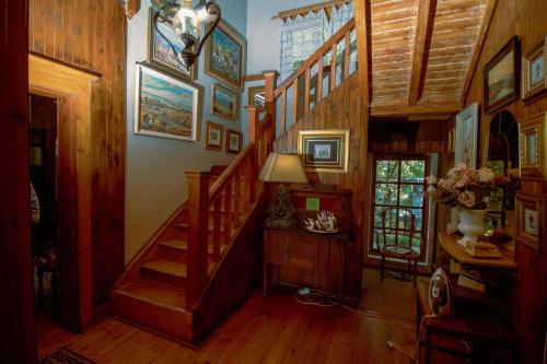 a staircase in a room with wooden walls and wooden floors at Pandora's guesthouse in Bethlehem