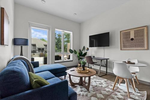 a living room with a blue couch and a table at Kirkland 1br w wd nr groceries shopping SEA-685 in Kirkland