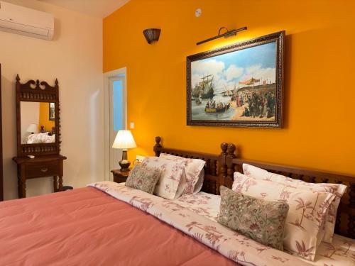 a bedroom with a bed with a painting on the wall at Terance Dale in Cochin