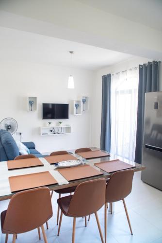 a dining room with a table and chairs at Sun Sea Living Gozo (Seagull) in Xlendi