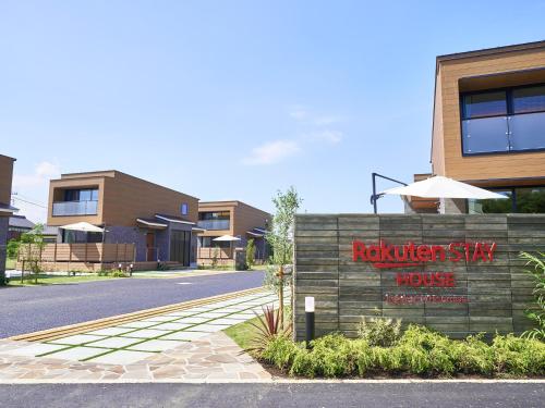a building with a sign for a roker stay house at Rakuten STAY HOUSE Kujukuri Ichinomiya in Ichigaya