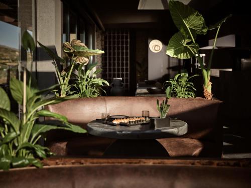 a room with plants and a table with food on it at Acro Suites - A Wellbeing Resort in Agia Pelagia