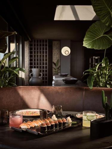 a table with plates of food on a table at Acro Suites - A Wellbeing Resort in Agia Pelagia
