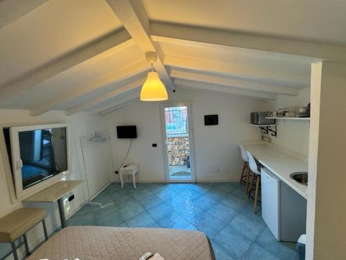 a room with a kitchen and a living room at CASA MEDUSA in La Spezia