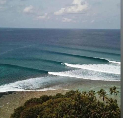 an aerial view of the ocean with waves at EQ SURF RETREAT in Muli