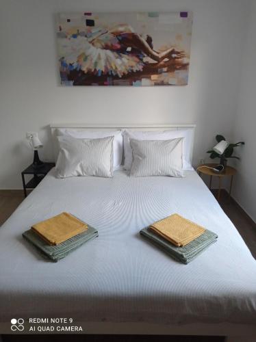 a bed with two towels on top of it at Apartman Linda in Krk