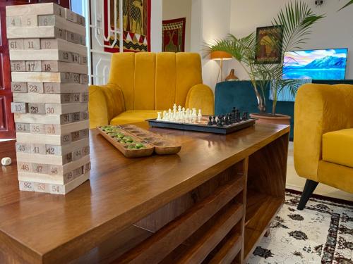 a living room with a chess board on a table at The Jewel and the Lake in Jinja
