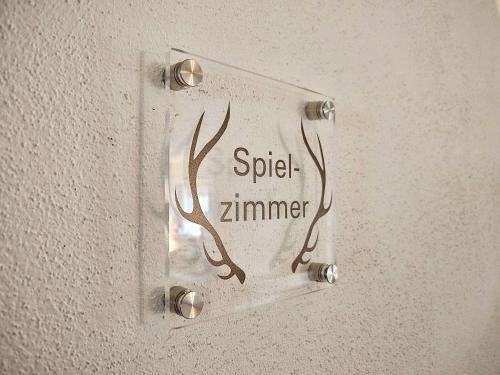a light switch with a sign on a wall at Gruppenhaus Alpenglück in Kirchdorf in Tirol