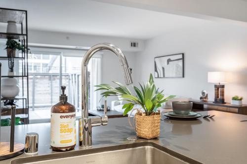 a bottle of wine sitting on a kitchen sink at Sharon Green apartments by FantasticStay in Menlo Park