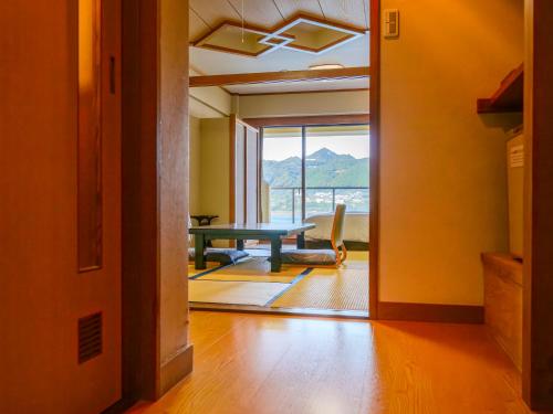 a room with a table and a chair and a window at KAMENOI HOTEL Nachi Katsuura Kumano Kodo in Nachikatsuura