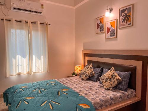 a bedroom with a bed and a window at 3BHK Home in Anjuna by Arzu Homes in Anjuna