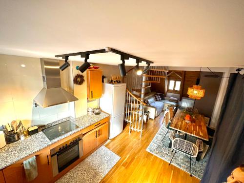 an aerial view of a kitchen and a living room at CASA CALEYDOS - Acogedor duplex con WIFI in Sallent de Gállego