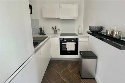 a white kitchen with a sink and a stove at Happy Home in Nice