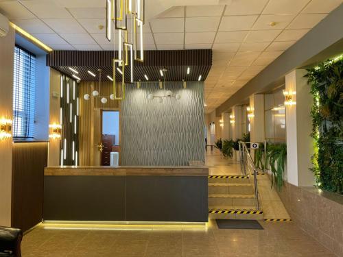 a lobby of an office building with a fountain at Tengri Hotel in Atyraū