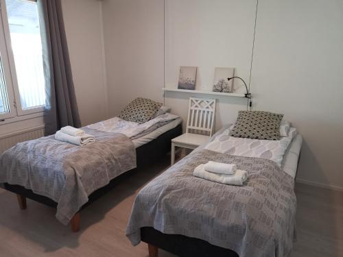 A bed or beds in a room at Hiisi Homes Nummela Härköilänsyrjä