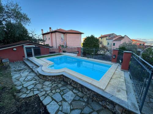 a swimming pool in a yard with a house at CASA MEDUSA in La Spezia