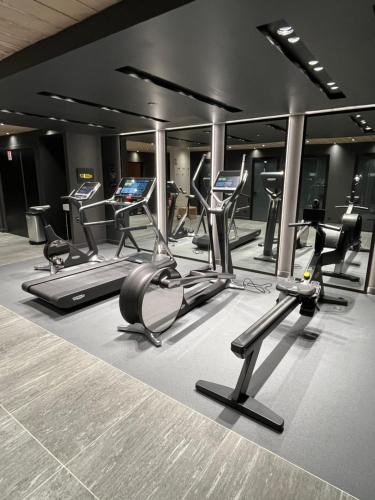 a gym with a bunch of exercise bikes and ellipticals at Standing Megeve - 2 to 8 people - Mont d'Arbois in Megève