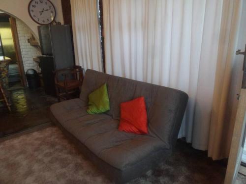 two colorful pillows on a couch in a living room at Serendipity self catering one bedroom apartment in Despatch