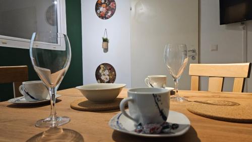 a wooden table with two wine glasses on it at APARTMENTS KREMSTAL in Imbach