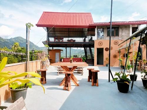 a patio with a table and benches and a building at Green View Peak in Gampola