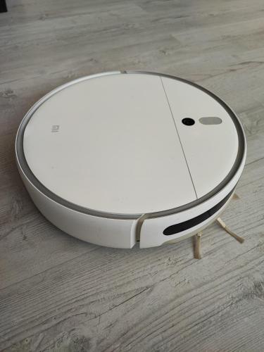 a white apple device sitting on a wooden floor at The nest above the clouds in Yakkasaray
