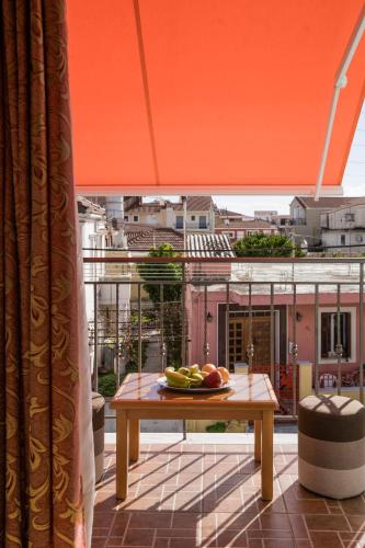 a plate of fruit on a table on a balcony at Belleza Villa in Lixouri