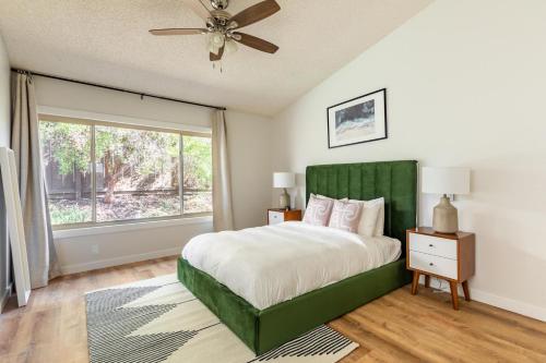 a bedroom with a bed with a green headboard and a window at Rancho Penasquitos 4br w wd nr trails parks SAN-41 in San Diego