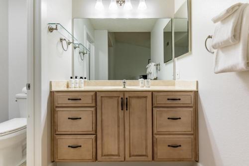 a bathroom with a sink and a mirror at Rancho Penasquitos 4br w wd nr trails parks SAN-41 in San Diego