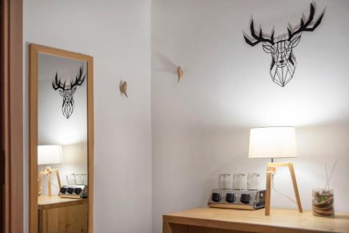 a room with two deer heads on the wall at Piccolo Hotel Aurora in Abbadia San Salvatore