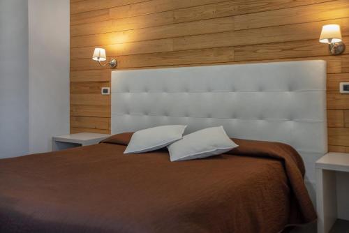 a bedroom with a large bed with two pillows at Piccolo Hotel Aurora in Abbadia San Salvatore