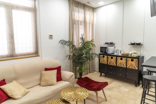 a living room with a couch and a table at Hotel Granada Centro in Granada