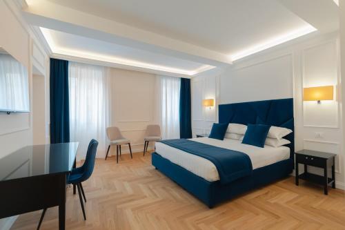a hotel room with a bed and a table and chairs at Relais del Portico in Rome