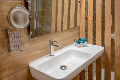 a sink in a bathroom with a mirror and a mirror at Piccolo Hotel Aurora in Abbadia San Salvatore