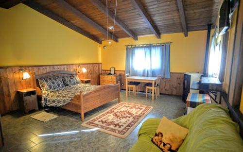 a bedroom with a bed and a desk and a couch at Agriturismo Casa delle Erbe 