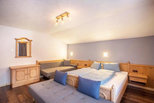 ein Schlafzimmer mit einem Bett und einem Sofa in der Unterkunft Schwüwong - Apartment 01 in Kelchsau
