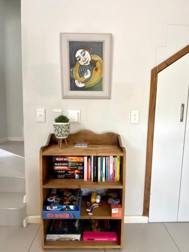 a book shelf filled with books in a room at Devine Stay in Paarl