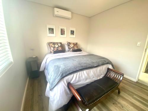 a bedroom with a bed and a chair in it at Devine Stay in Paarl