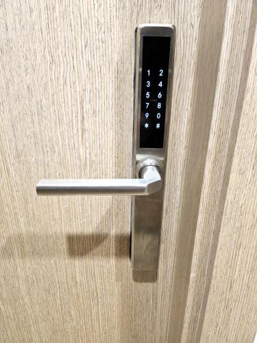 a close up of a door handle on a wooden door at Kauno apartamentai big room king size bed in Kaunas