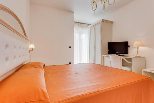 Ένα ή περισσότερα κρεβάτια σε δωμάτιο στο Hotel Buratti