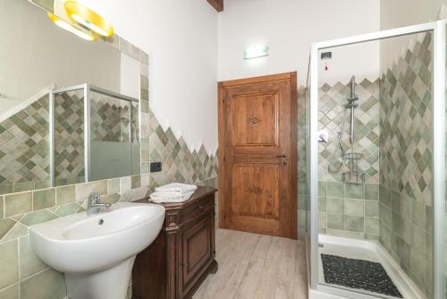 La salle de bains est pourvue d'un lavabo et d'une douche. dans l'établissement Residenza del golfo, à Telti