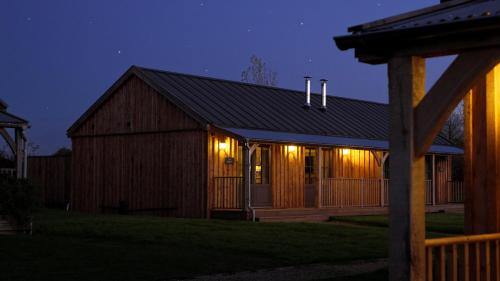 a barn with lights on it at night at Retreat East in Ipswich