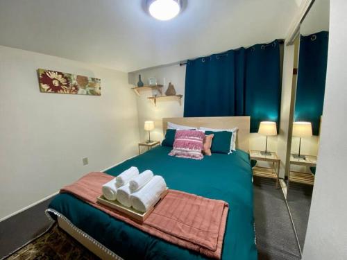 Un dormitorio con una cama verde con toallas. en ST1B Convenient Villa Seattle downtown closeby en Seattle