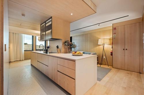 a kitchen with a counter with a bowl of fruit on it at Exclusive Terrace Apartment at Savoy Insular in Funchal