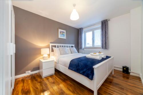 a bedroom with a white bed and a window at Amazing 1 BR apartment, Barons Court in London
