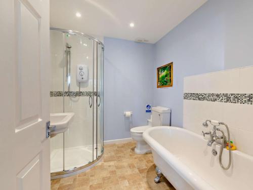 a bathroom with a shower and a tub and a toilet at 3 Bed in Bruton HTORV in Castle Cary