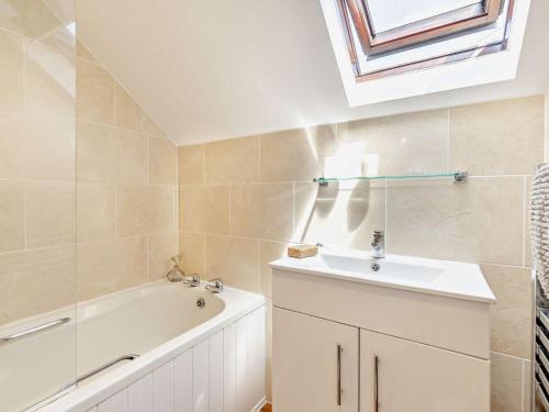 a bathroom with a sink and a bath tub at 3 Bed in Exeter KENCI in Clyst Saint Mary